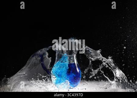 Water explosion in water vessel, blue with fountain Stock Photo