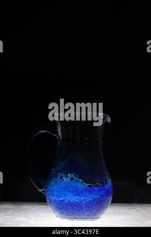Water explosion in water vessel, blue Stock Photo