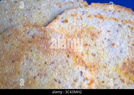 Flatbread crackers with seeds on a blue background Stock Photo