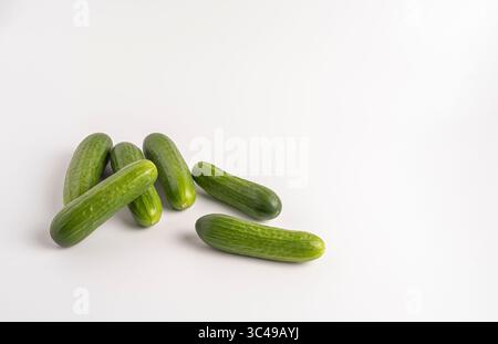 Fresh green cucumbers isolated on white background, crisp, organic, and ready to eat. Stock Photo