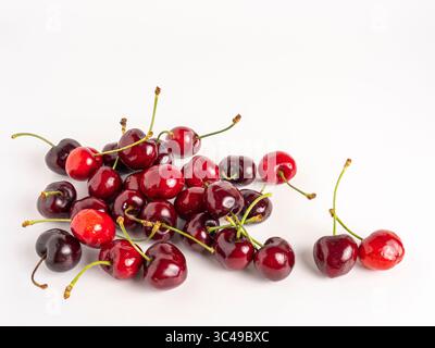 Fresh red and dark cherries with stems, isolated on white background. Stock Photo