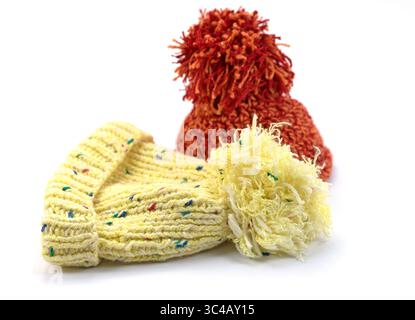 Two bobble hats against a white background Stock Photo