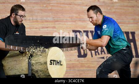 July 27, 2018 - Milwaukee, Wisconsin, U.S - Using a ''single buck'' saw, WALT PAGE (right) of Tollhouse, CA, starts cutting through a 19-inch diameter log.  Milwaukee's German Fest hosted this year's STIHL TIMBERSPORTS U.S. Championships. (Credit Image: © Rob Dicker via ZUMA Wire) Stock Photo