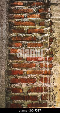 Red bricks neatly arranged to form a wall, showcasing construction precision and the durability of traditional building materials. Stock Photo