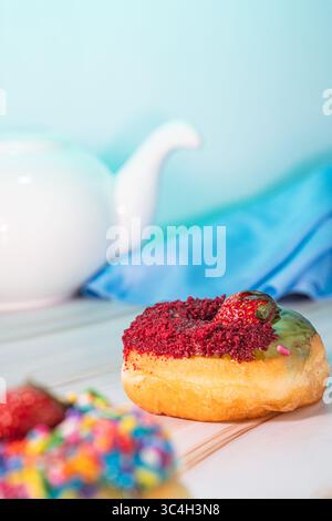 Mini donuts with chocolate and strawberry toppings, captured in a low angle macro shot. Ideal for food blogs, dessert menus, pastry ads, or culinary c Stock Photo