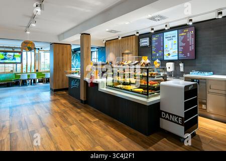 A brightly lit and spacious modern McCafé interior view in Vienna, Austria. Stock Photo