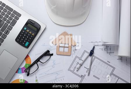 Creative layout of architects with roll drawings, architectural project plan, statistical graphs, engineering tools and stationery, laptop on white ba Stock Photo