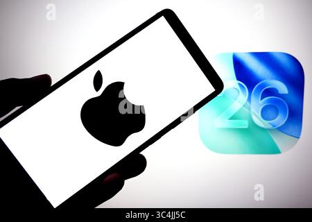 In this photo illustration, an Apple logo is seen displayed on a smartphone with an IOS 26 logo in the background. (Photo by Avishek Das / SOPA Images/Sipa USA) *** Strictly for editorial news purposes only *** Stock Photo