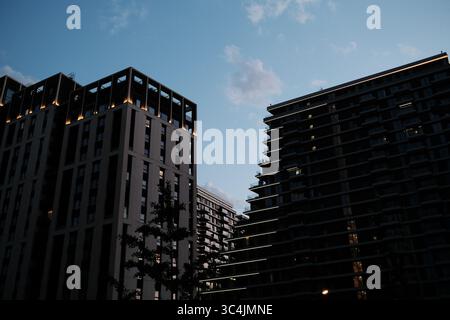 Evening view of illuminated buildings in Belgrade Waterfront with clean modern design and glowing lines. Stock Photo