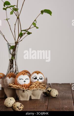 Funny owl family. Hand drawn owl Easter eggs, quail eggs and bird feathers. Space for your text. Stock Photo
