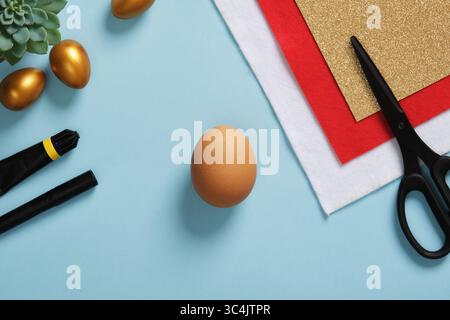 DIY Easter Egg King. Step-by-step instructions. Step 1. Take eggshells, red and white felt, gold cardboard, glue, black felt pen, scissors. Stock Photo