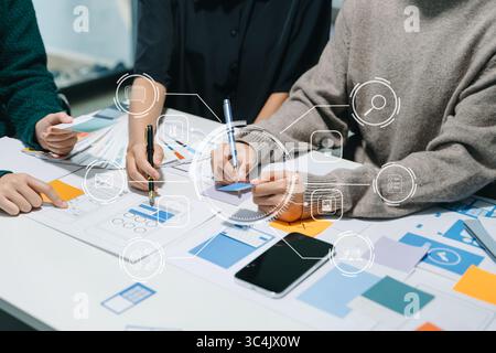 Asian businessman and woman people meeting in office. Employee brainstorm and work as team, plan and discuss project by point on paper and tablet. Stock Photo