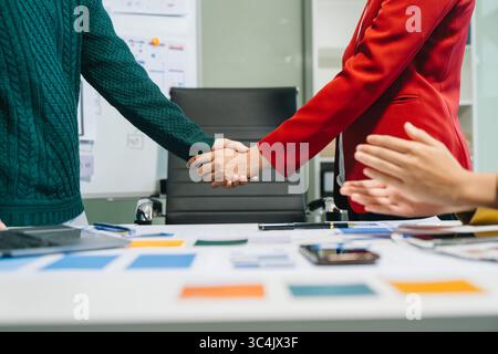 Close up view of UI developer team brainstorming on their project with laptop, smartphone and digital tablet. Creative digital development agency. Stock Photo