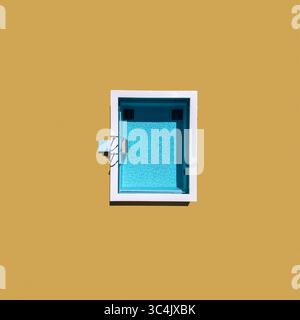 Aerial view of a vivid turquoise pool framed by stark white against a warm yellow wall, a geometric dance of color and form, Split, Split-Dalmatia Cou Stock Photo