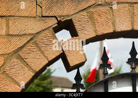 Brick falling from arch in wall which could lead to collapse. Caused by settlement or foundation movement. UK. Health and safety hazard danger. (145) Stock Photo