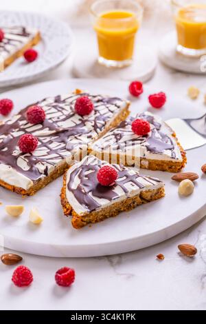 Homemade flat carrot cake with nuts, iced with cream cheese and carrot juice Stock Photo