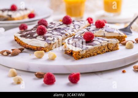 Homemade flat carrot cake with nuts, iced with cream cheese and carrot juice Stock Photo