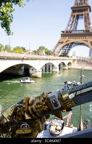 Love locks padlocks on Seine bridge railing with Eiffel Tower background Paris, France Stock Photo