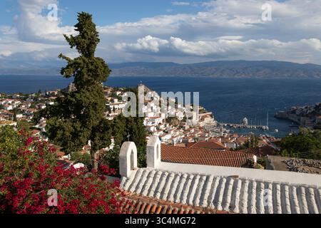 View over whitewashed houses and the port with Greek Orthodox church in foreground, Hydra, Saronic Islands, Greek Islands, Greece, Europe Stock Photo