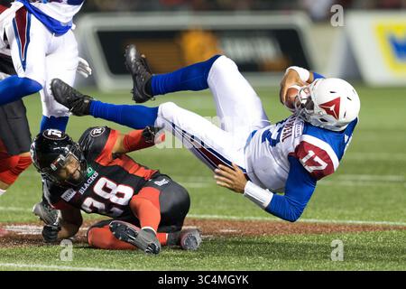 August 31, 2018: Montreal Alouettes quarterback Antonio Pipkin (17) is sent flying tackled by Ottawa Redblacks Corey Tindal (28) during the CFL game between Montreal Alouettes and Ottawa Redblacks at TD Place Stadium, in Ottawa, Canada. Daniel Lea/CSM.(Credit Image: &copy; Daniel Lea/CSM via ZUMA Wire) Stock Photo
