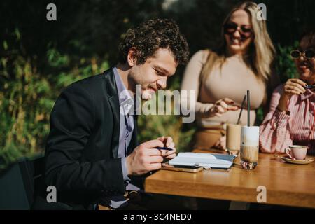 Group of business colleagues having an outdoor meeting over coffee Stock Photo