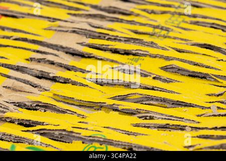 Abstract background of brown cardboard with cuts and yellow patches. Recycling, shipping concept Stock Photo