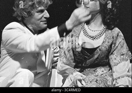 'What Every Girl Should Know', Robert Long and Dimitri Frankel Frank, Robert Long, 28-01-1978 Whizgle News, Dutch Desk, The Netherlands, 1950-2000 A man in a suit interacts with a woman dressed in a patterned gown and pearls, creating an intriguing dynamic as he raises a glass in her direction. The scene captures a moment of engagement between the two, hinting at a narrative filled with charm and mystery. Stock Photo