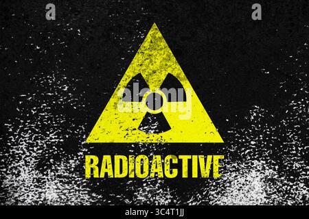 Radioactive sign on black textured surface. Radiological pollution Stock Photo
