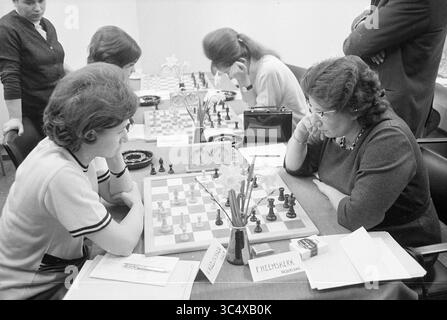 Ladies and gentlemen chess tournamentable, 17-01-1968 Whizgle News, Dutch Desk, The Netherlands, 1950-2000 Two women engage in a tense chess match, deep in concentration as they strategize their next moves. Spectators observe the game closely, while the tables are adorned with chess pieces and scorecards, reflecting a competitive atmosphere. Stock Photo