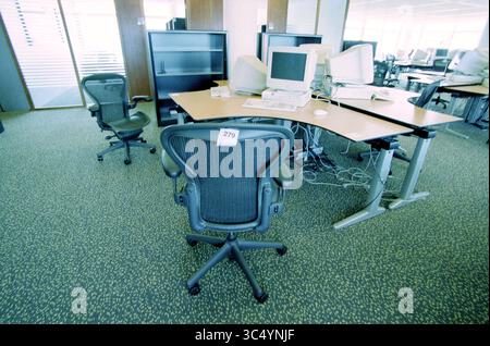 Auction KPN Q-west, Hoofddorp, The Netherlands, 08-08-2002 Whizgle News, Dutch Desk, The Netherlands, 1950-2000 An office space featuring modern ergonomic chairs and multiple workstations, complete with computer monitors and tangled cables. The layout suggests a functional environment ready for productivity. Stock Photo