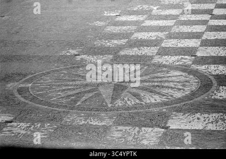 Precursor Wind Rose on the Grote Markt, Haarlem, Grote Markt, The Netherlands, 00-00-1966 Whizgle News, Dutch Desk, The Netherlands, 1950-2000 A detailed design featuring a large compass rose at the center, surrounded by a checkerboard pattern. The textures and shapes create a striking visual contrast, emphasizing the intricate craftsmanship of the surface design. Stock Photo