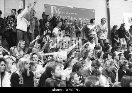 Handball, Netherlands - Switzerland, 26-11-1992 Whizgle News, Dutch Desk, The Netherlands, 1950-2000 A lively crowd of students passionately cheering and celebrating at a school event, with some holding up their hands in excitement and others displaying expressions of enthusiasm. The atmosphere is filled with energy as spectators engage with the happenings on the court. Stock Photo