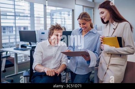 Engaging in a Collaborative Team Discussion within a Modern Office Setting for Enhanced Performance Stock Photo