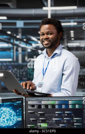 Portrait of cheerful admin using artificial intelligence computing ...