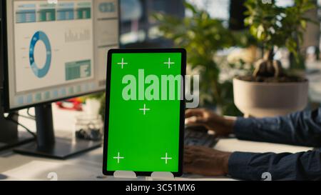 Close up of isolated screen tablet used by worker in office reviewing financial graphs. Employee looking over data trends and strategic insights on mockup tablet, analyzing KPIs, camera A Stock Photo