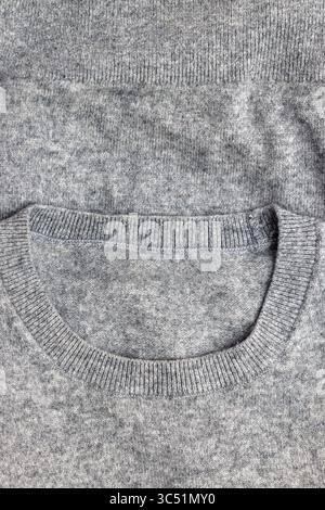 A detailed close-up of a gray knit fabric, showcasing its texture and pattern. Stock Photo