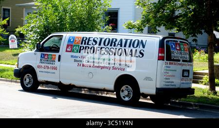 Restoration Professionals truck in the neighborhood restoring homes after environmental damage like water, fire and storms. St Paul Minnesota MN USA Stock Photo