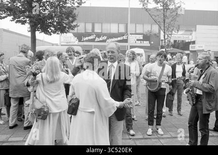 Opening of the black market on late evening, Market, Opening, openings, putting into use, 01-09-1983 Whizgle News, Dutch Desk, The Netherlands, 1950-2000 A lively street scene with a crowd enjoying a festive atmosphere. People are mingling, some dancing while others engage in conversation. Musicians play lively tunes in the background, adding to the cheerful ambiance. The setting has an air of community and celebration. Stock Photo