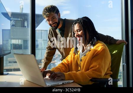 Business colleagues working together on laptop in office. Stock Photo
