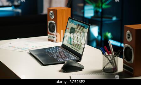 Spacious home office in a stylish apartment featuring wooden floors, a TV and decorative plants create a home office setup perfect for comfort and functionality, productivity and efficiency. Stock Photo