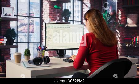 AI chatbot application displayed on a desktop computer for solutions, helping streamline text based tasks. Woman showcases innovation, automation and machine learning for seamless support. Camera B. Stock Photo