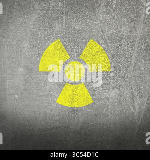 Yellow radioactive sign on grey stone background. Radiological pollution Stock Photo