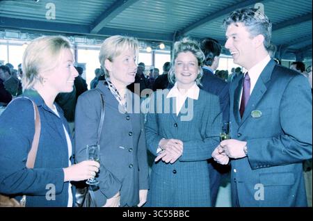 Opening Holiday Inn Hotel, IJmuiden, Kennemerboulevard, The Netherlands, 14-04-1999 Whizgle News, Dutch Desk, The Netherlands, 1950-2000 A group of four professionals engage in a lively conversation at a networking event, showcasing a vibrant atmosphere. Two women hold glasses, while the man in a suit shares a smile, highlighting a moment of camaraderie and connection among colleagues. Stock Photo