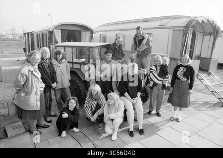 Group of caravan residents Zuiderpolder, caravans, caravan camps, caravan dwellers, 30-03-1990 Whizgle News, Dutch Desk, The Netherlands, 1950-2000 A diverse group of individuals gathers around a vintage caravan and tractor, showcasing a mix of styles and expressions. Some members pose confidently in front, while others perch atop the vehicle, creating a lively sense of camaraderie and nostalgia. Stock Photo