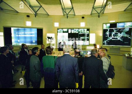 Opening of traffic center by Minister Annemarie Jorritsma, 30-09-1997 Whizgle News, Dutch Desk, The Netherlands, 1950-2000 A group of people gathers in a high-tech control room, attentively observing multiple large screens displaying data and maps. The atmosphere reflects a sense of engagement and curiosity as they explore the information being presented. Stock Photo