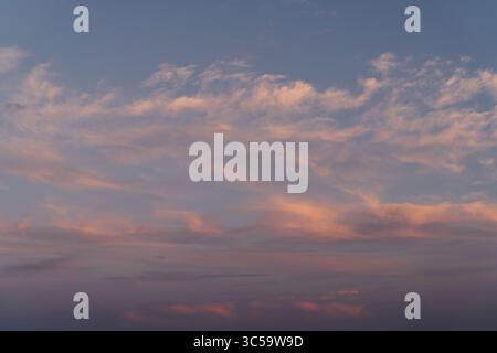 Horizon Glow with Soft Pink and Purple Wisps Stock Photo