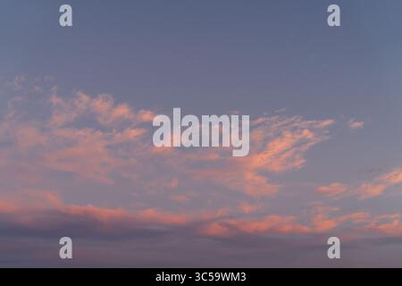 Pink Clouds at Dusk with Soft Pastel Tones Stock Photo