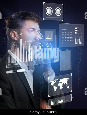 Business professional analyzing financial data with digital interfaces in a modern office environment Stock Photo