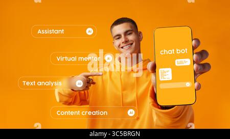 Engaging young man showcasing chatbot features on smartphone against bright orange background Stock Photo
