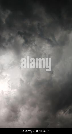 Dark storm clouds gathering in the sky, creating a dramatic and moody atmosphere before a thunderstorm. Stock Photo